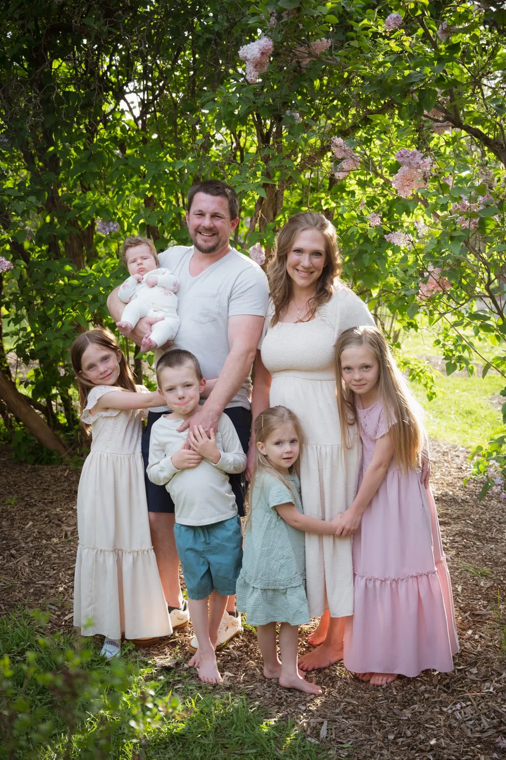 Kaleb Fisher with his wife and children outdoors