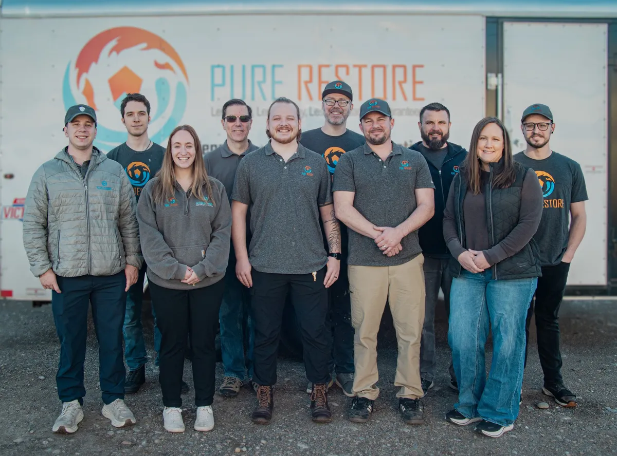 The Pure Restore crew standing in front of the company trailer
